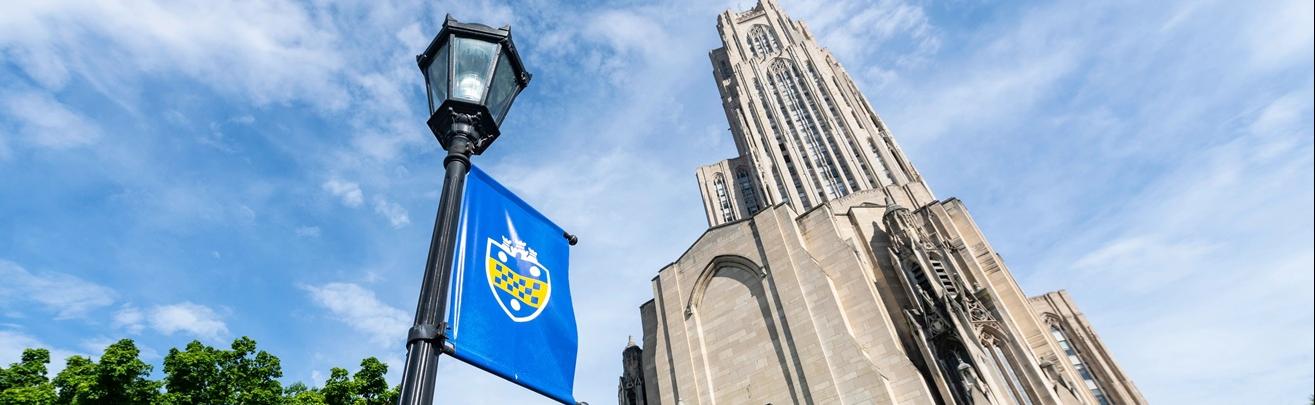 Perspective view of Cathedral of Learning with Pitt banner in foreground